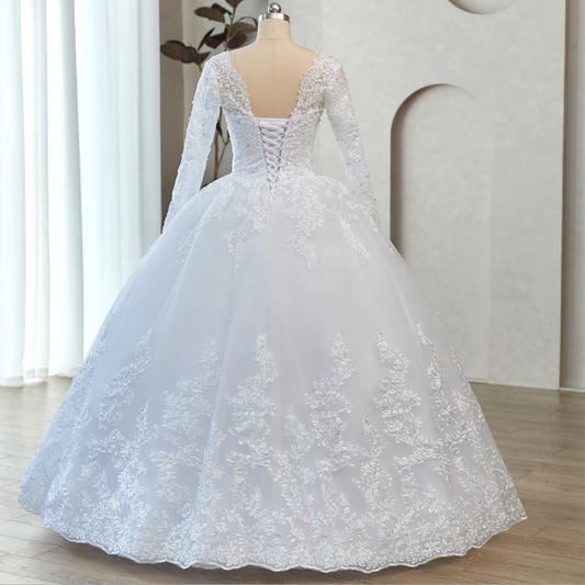 White Christian bridal ball gown featuring floral lace appliqué, long sleeves, and a luxurious tulle skirt