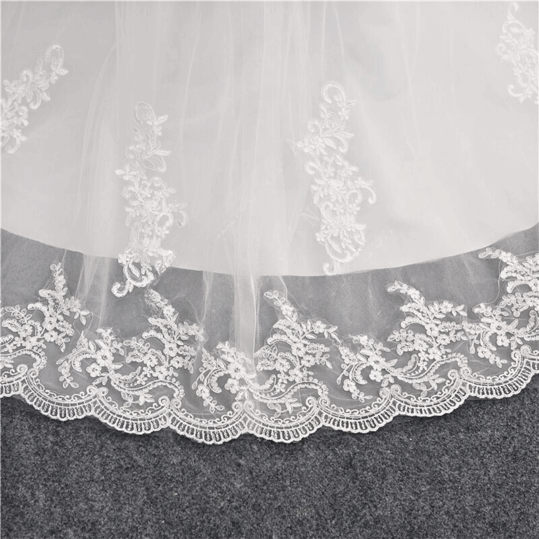 Timeless Christian lace wedding gown by GownLink with elegant long sleeves, floral embroidery, and a graceful bridal silhouette