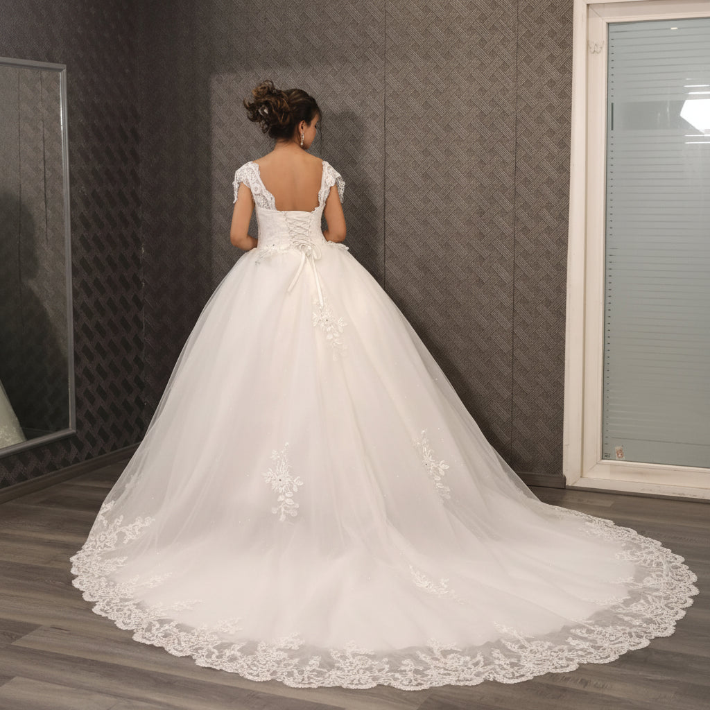 Three-quarter view of White Bridal Gown with Train on model — GownLink GLQTH343