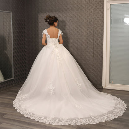 Three-quarter view of White Bridal Gown with Train on model — GownLink GLQTH343