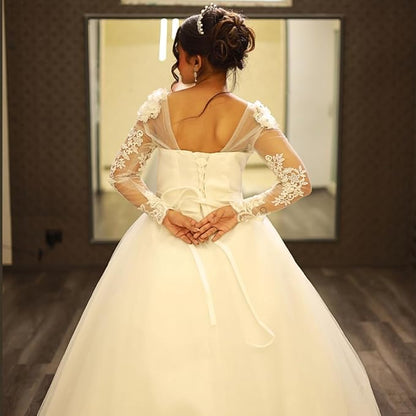 Premium white formal bridal dress with sheer lace sleeves and princess silhouette