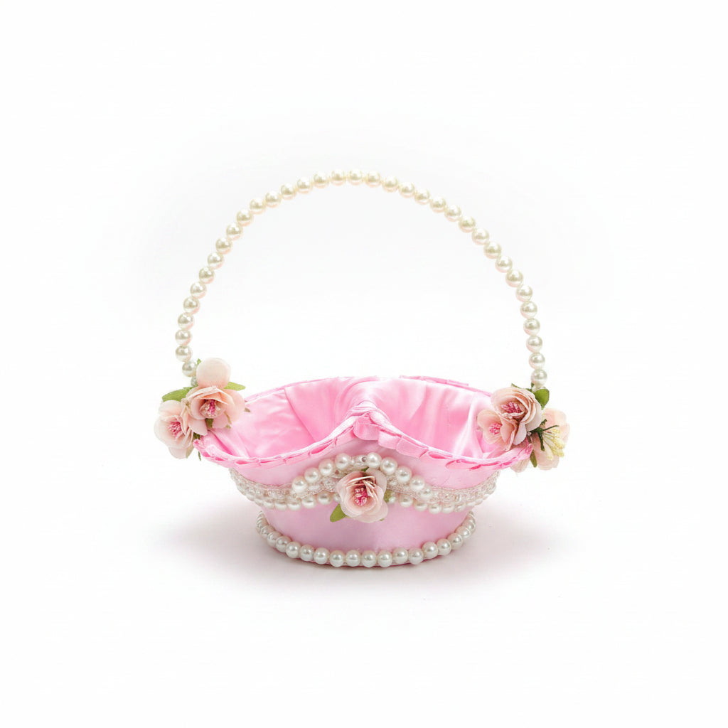 A decorative pink satin handbag with a pearl-bead handle and trim, adorned with small white and pink flowers, resting on a brown quilted chair.