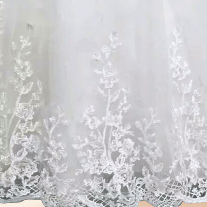 White bridal gown for church weddings featuring a modest neckline, lace sleeves, and elegant embroidery
