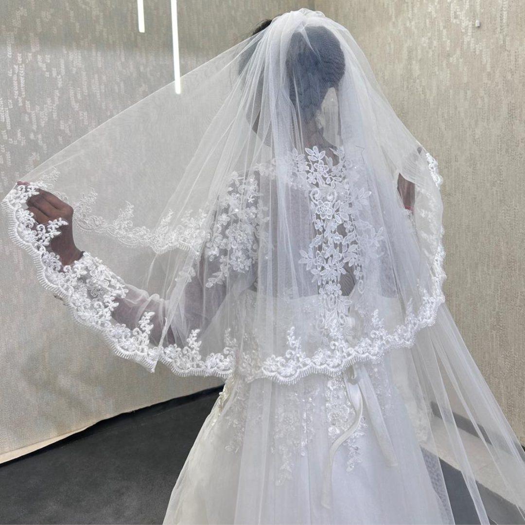 White bridal veil with decorative lace border for wedding gown