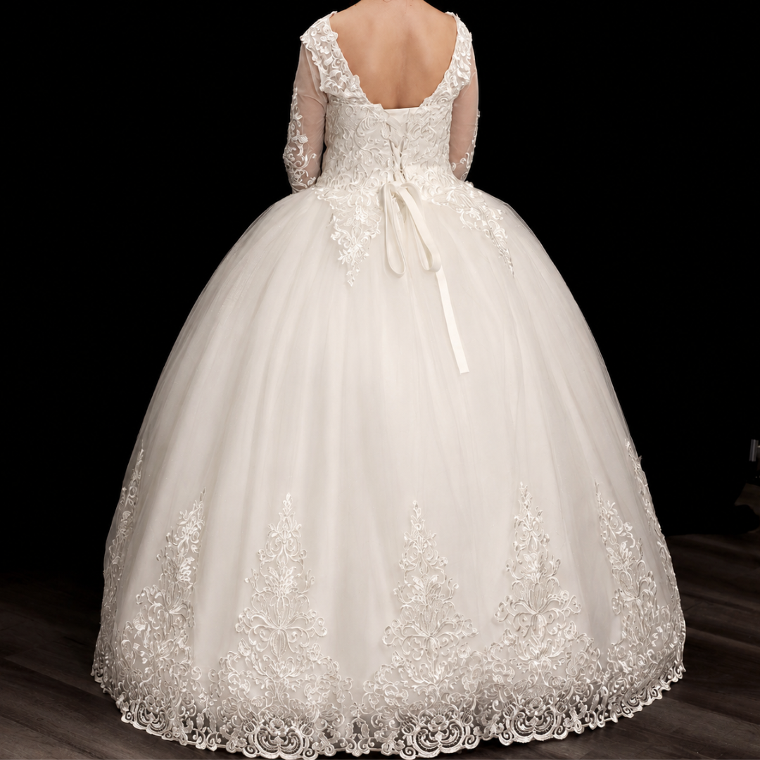 Christian bridal gown with a layered tulle skirt, illusion bodice, and delicate lace appliqué
