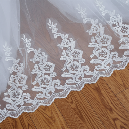 Classic Christian wedding ball gown with elegant lace appliqué and a graceful flowing train