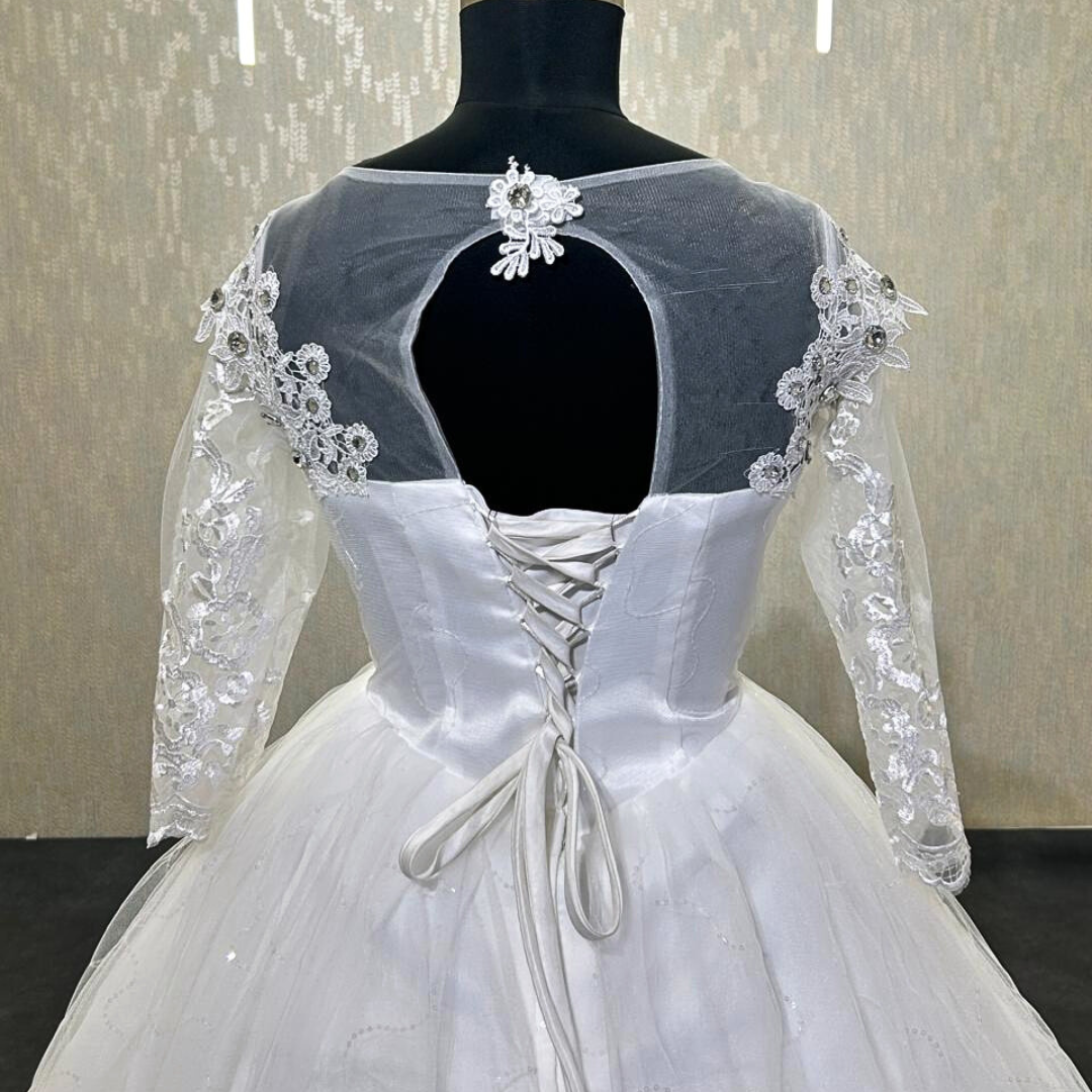 Designer Christian bridal gown with intricate floral lace work and elegant silhouette