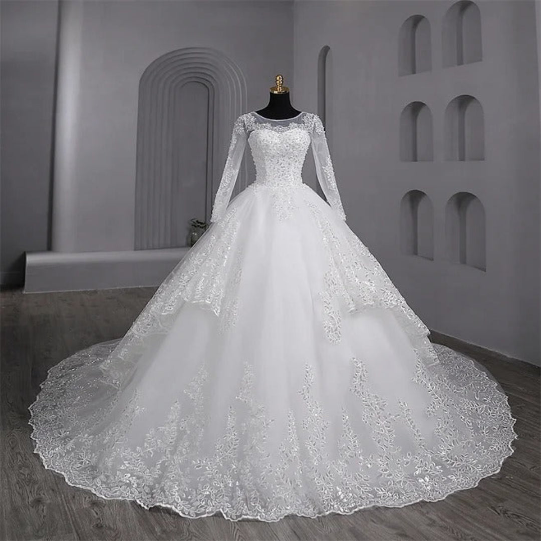 Designer Christian wedding gown by GownLink with elegant lace sleeves and layered bridal styling