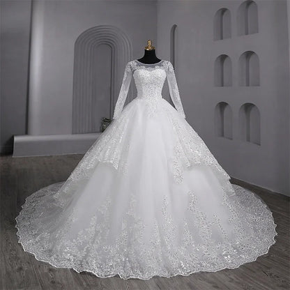 Designer Christian wedding gown by GownLink with elegant lace sleeves and layered bridal styling