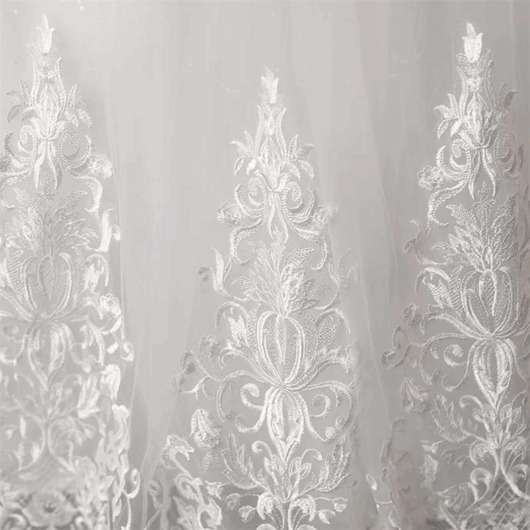 Designer white Christian bridal gown with intricate embroidery and a romantic layered silhouette