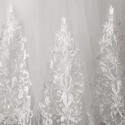 Designer white Christian bridal gown with intricate embroidery and a romantic layered silhouette