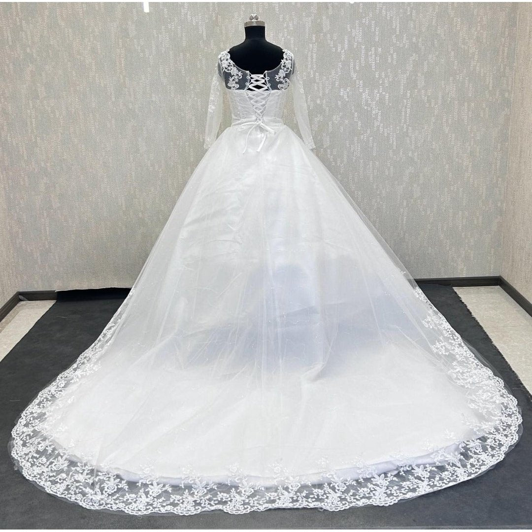 Elegant church ceremony bridal gown with lace appliqué and a sophisticated princess-style design