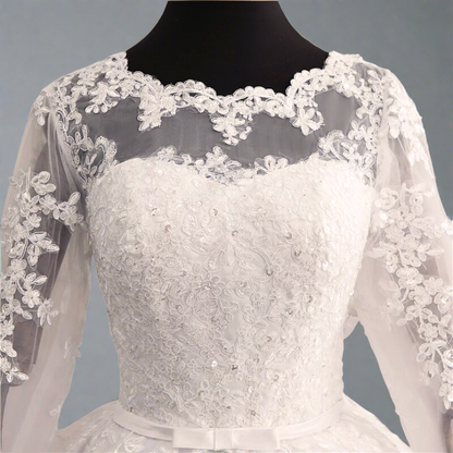 Embroidered white Christian bridal gown with floral lace and cathedral-inspired design