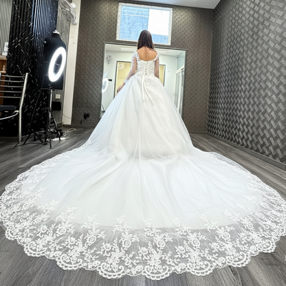 Three-quarter view of White Bridal Gown with Long Train on model — GownLink GLHSD189T