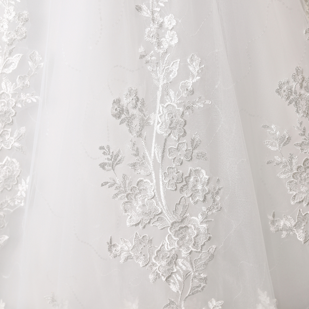 "Elegant ivory-white lace Christian wedding gown."