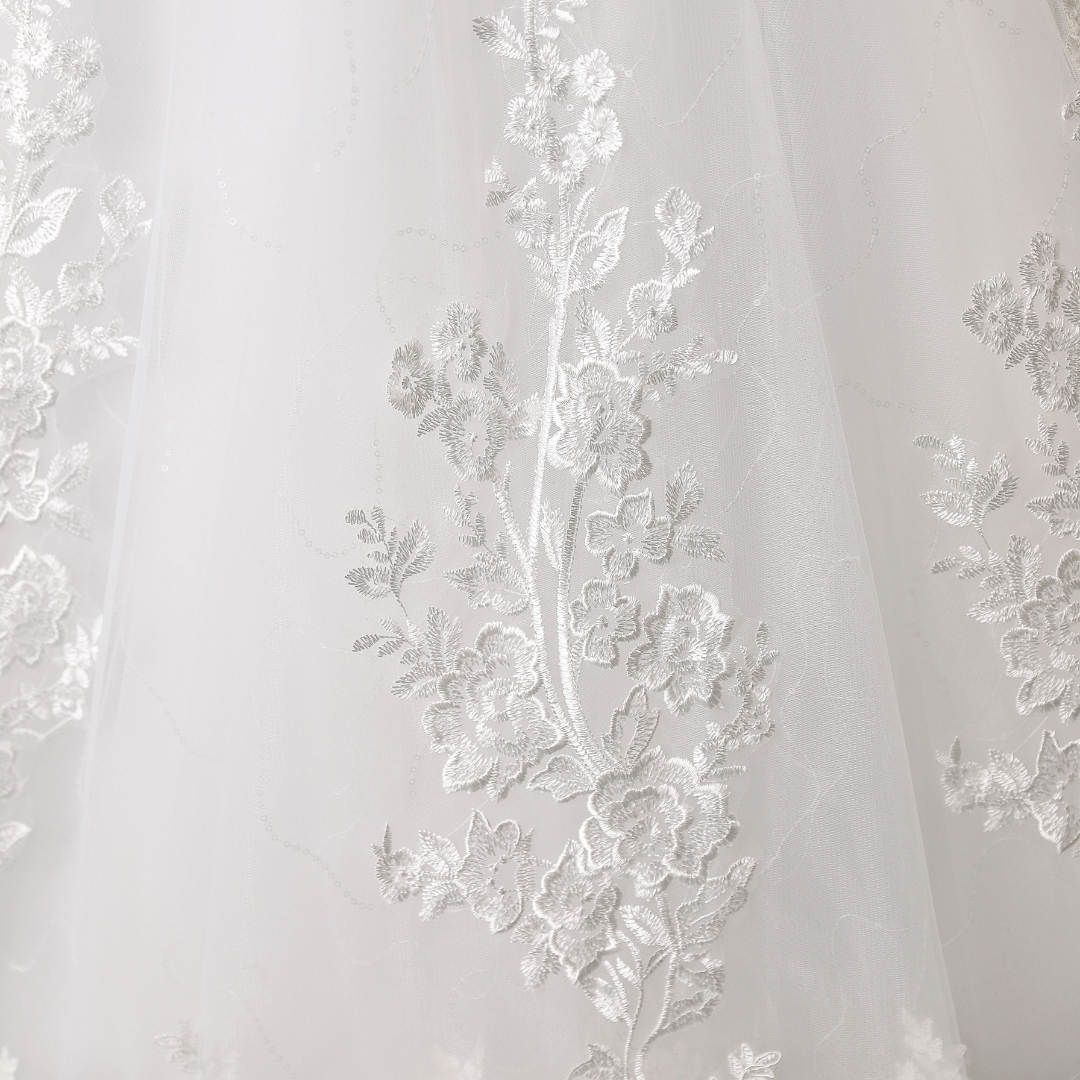 "Delicate lace train-style Christian bridal dress."