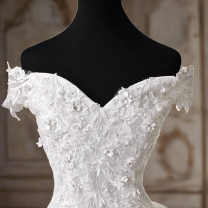 Off-the-shoulder train gown for a Christian wedding."