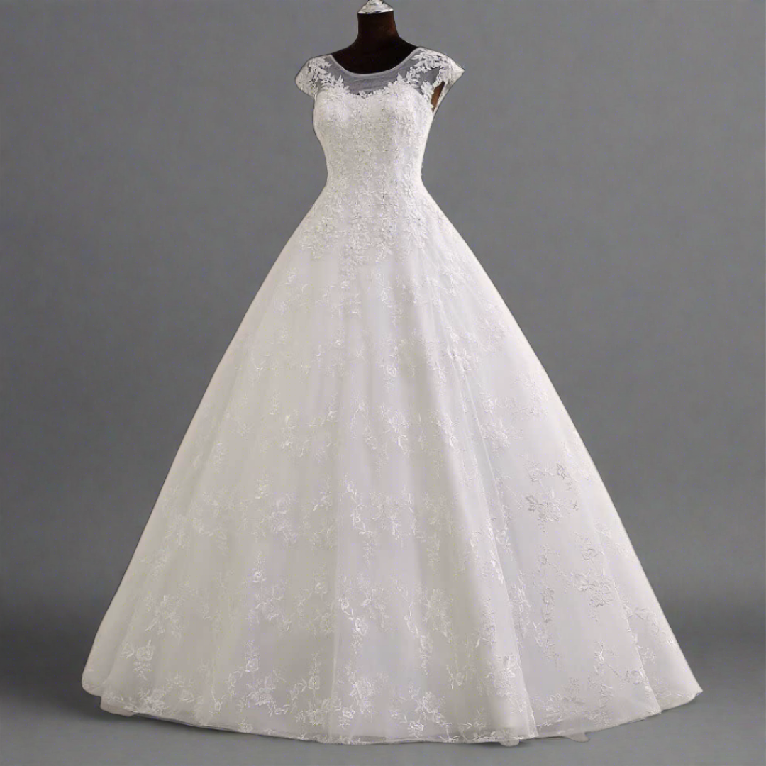 "A line white gown showcasing a beaded illusion neckline."