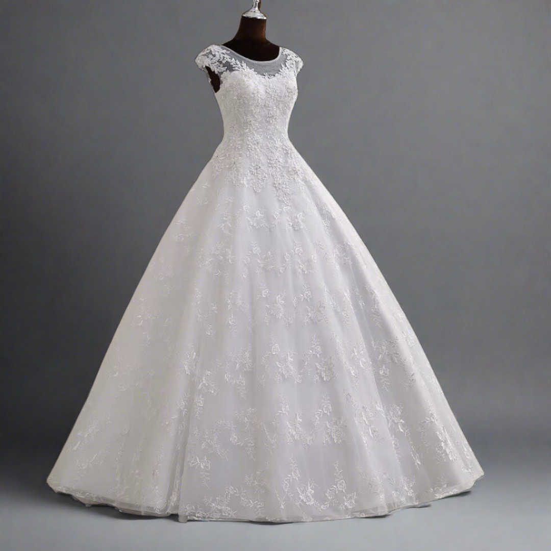 "Graceful A-line white christen wedding gown with a tulle skirt."