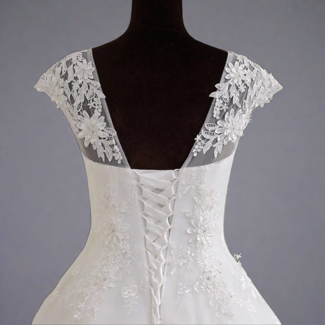 "Christian white wedding gown with a beaded patch work."