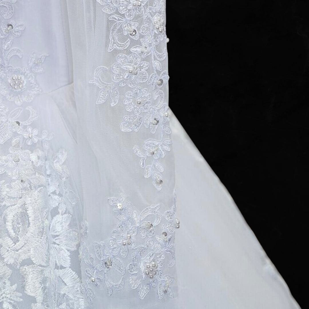 "Exude grace and poise in this splendid white ball gown for a Catholic ceremony."