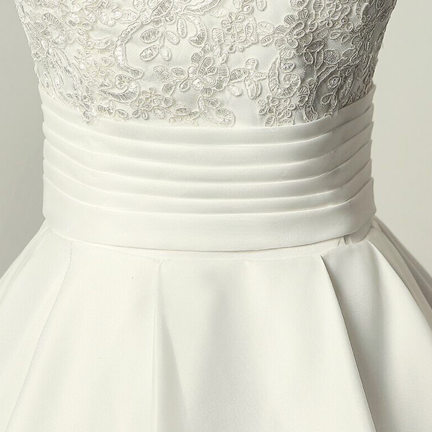 Embellished white Catholic wedding dress waist plate with a regal train.