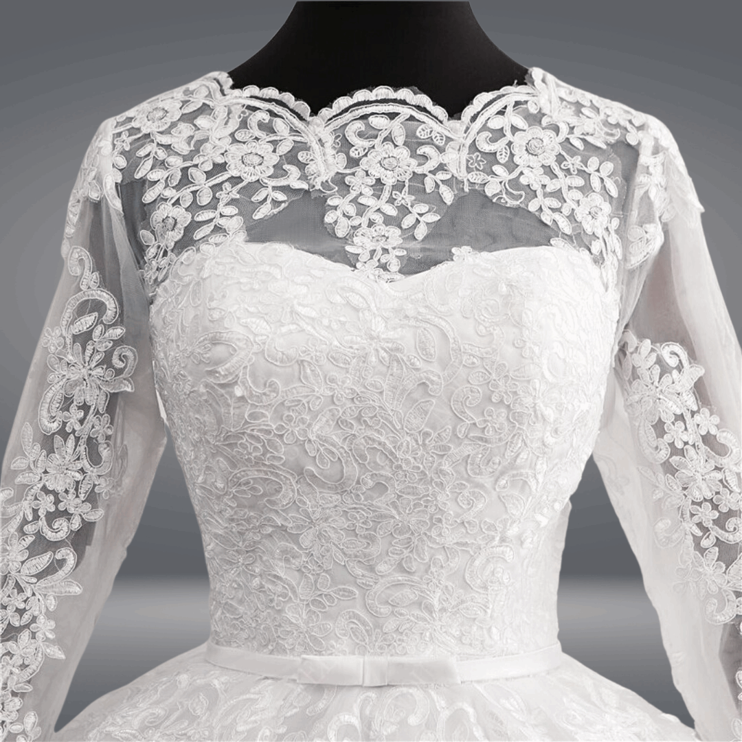 Regal white ball gown featuring a beaded illusion neckline and full sleeves.