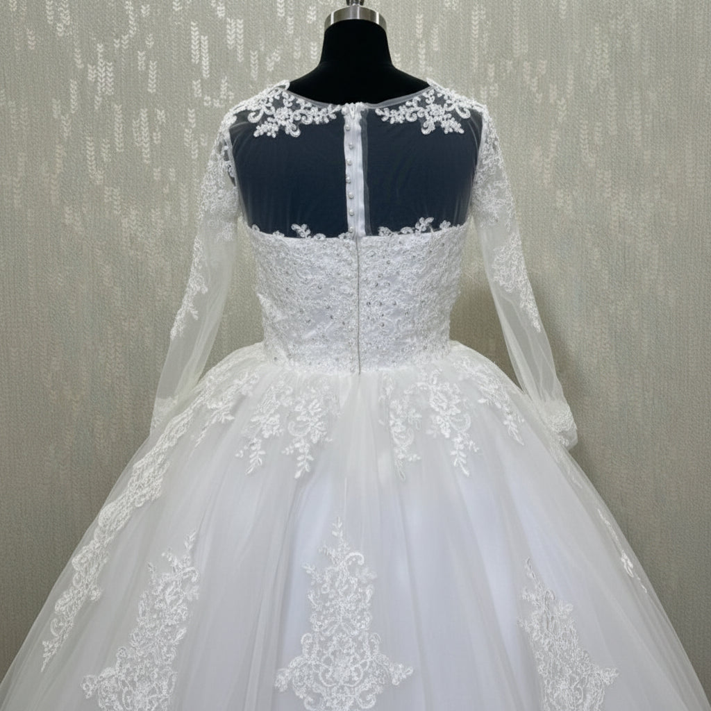 Christian wedding gown with long lace sleeves, illusion neckline, and floral lace hem