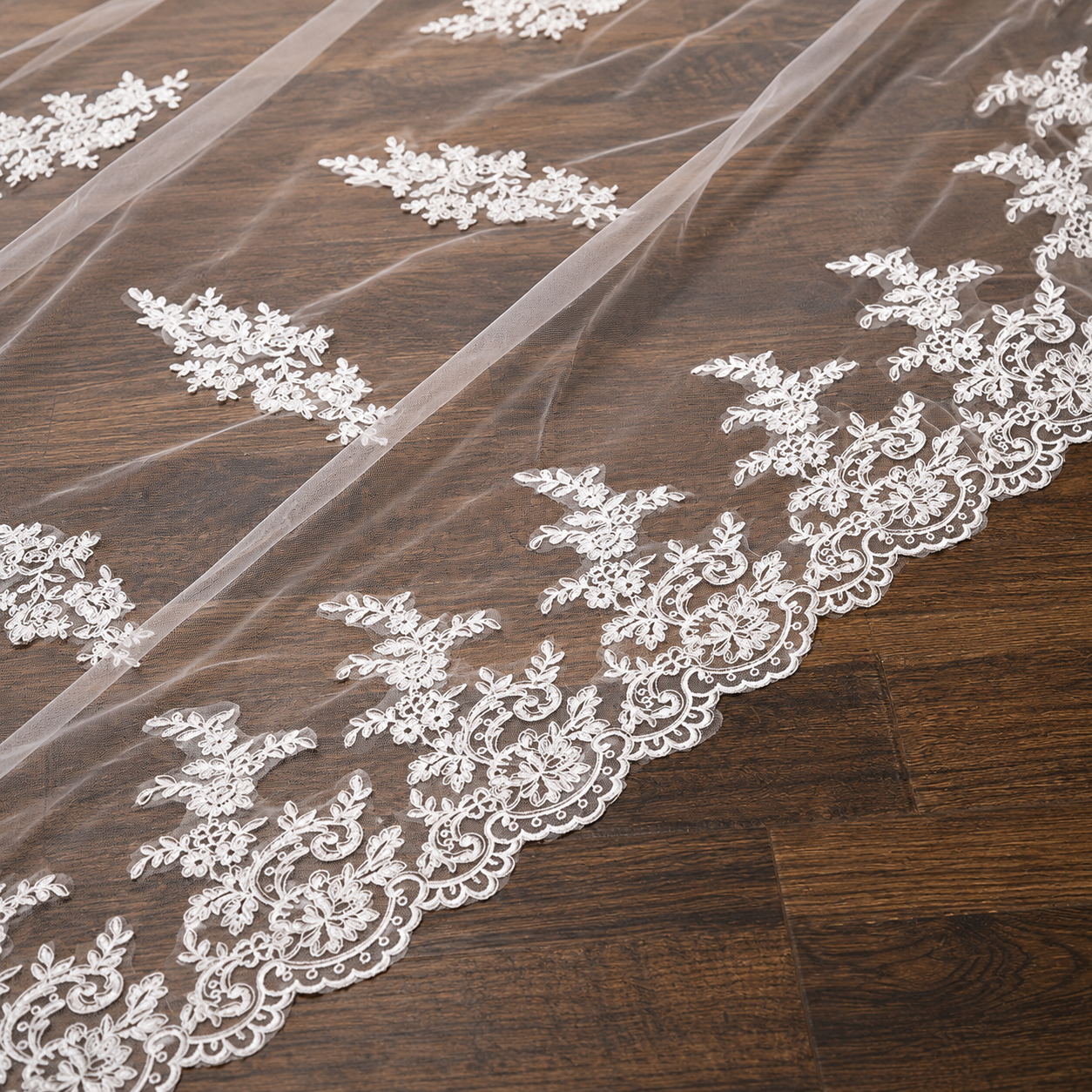 Classic white cathedral veil with floral lace edging for Christian bridal church ceremony attire.