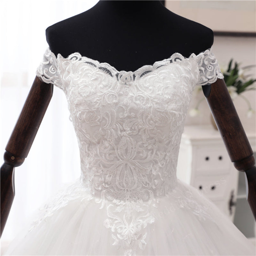Christian bridal gown with intricate lace hem, cathedral-inspired train, and elegant silhouette
