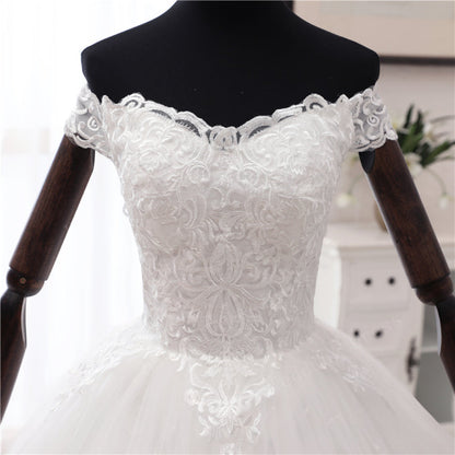 Christian bridal gown with intricate lace hem, cathedral-inspired train, and elegant silhouette