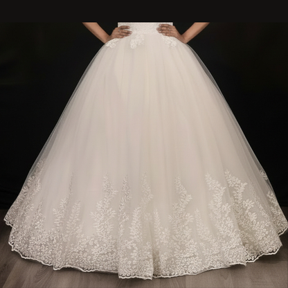 Classic white Christian bridal gown with lace sleeves, floral embroidery, and timeless elegance