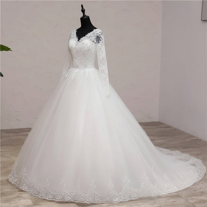Classic white Christian wedding dress with long lace sleeves and embroidered lace hem