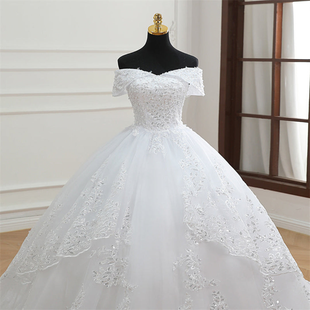 Classic white Christian wedding gown with off-shoulder sleeves, lace embroidery, and elegant long train