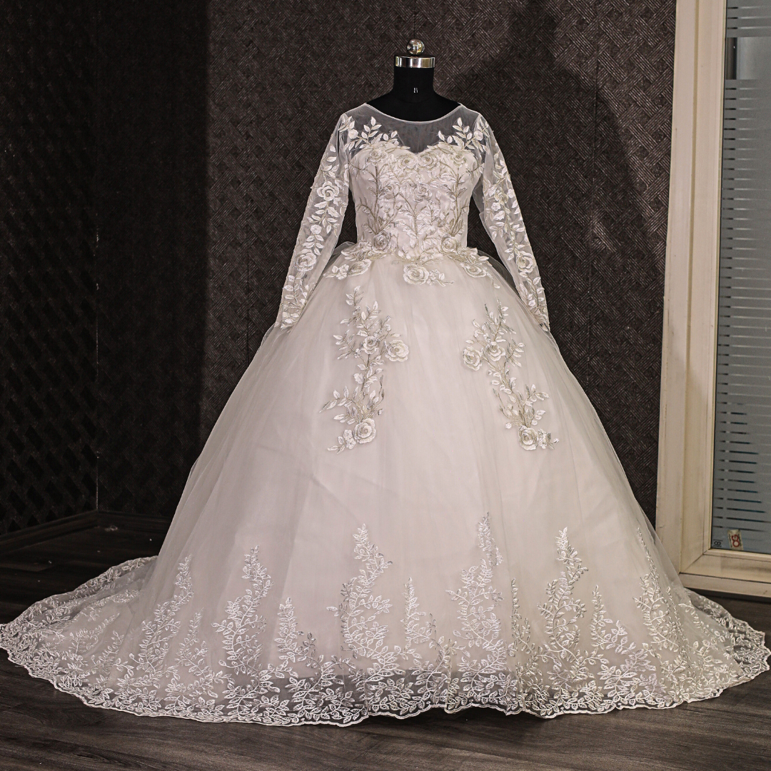 Classic white Christian wedding gown with floral lace details, long sleeves, and timeless bridal elegance
