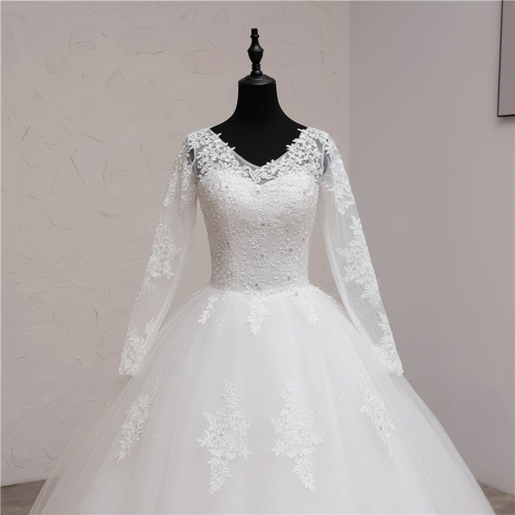 Designer Christian bridal gown with illusion lace sleeves, floral appliqués, and elegant cathedral train