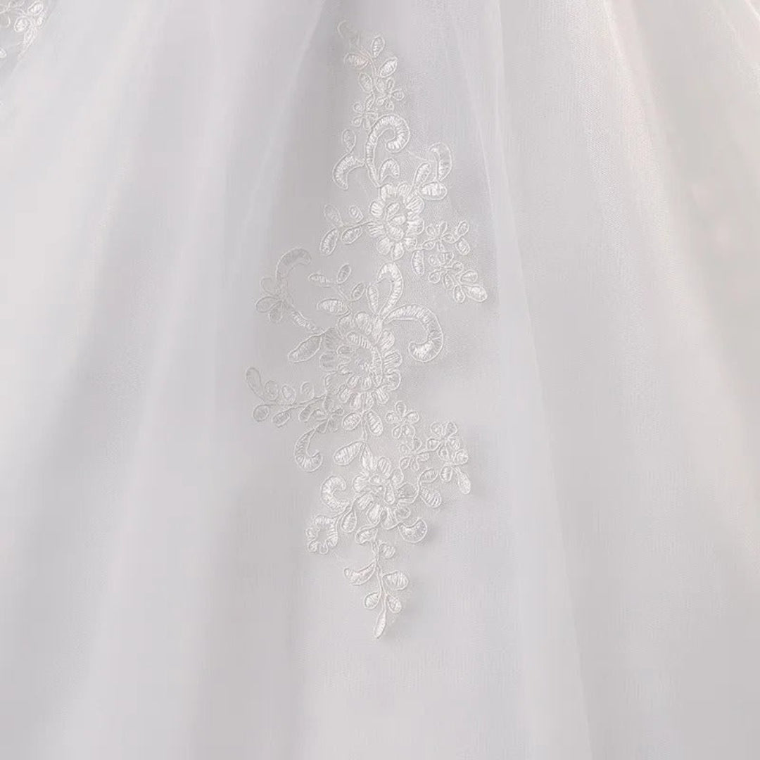Designer Christian wedding gown with embroidered lace details and romantic long train