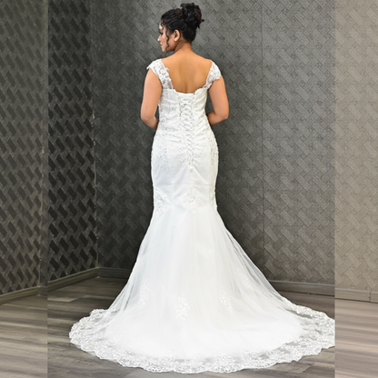 Designer Christian bridal gown with crystal-embellished lace bodice and flowing mermaid skirt