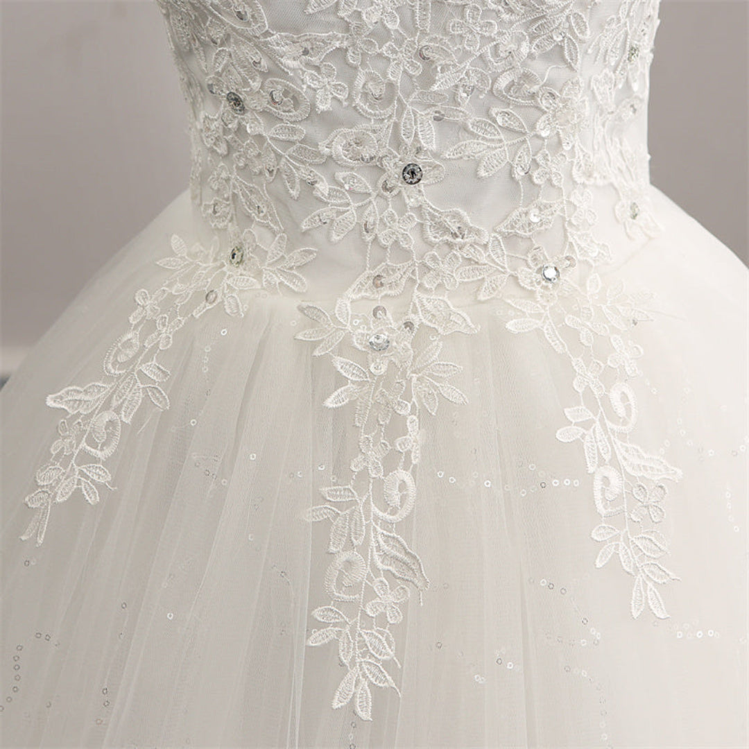 Elegant Christian wedding dress with intricate lace appliqué and soft tulle skirt for a sophisticated ceremony