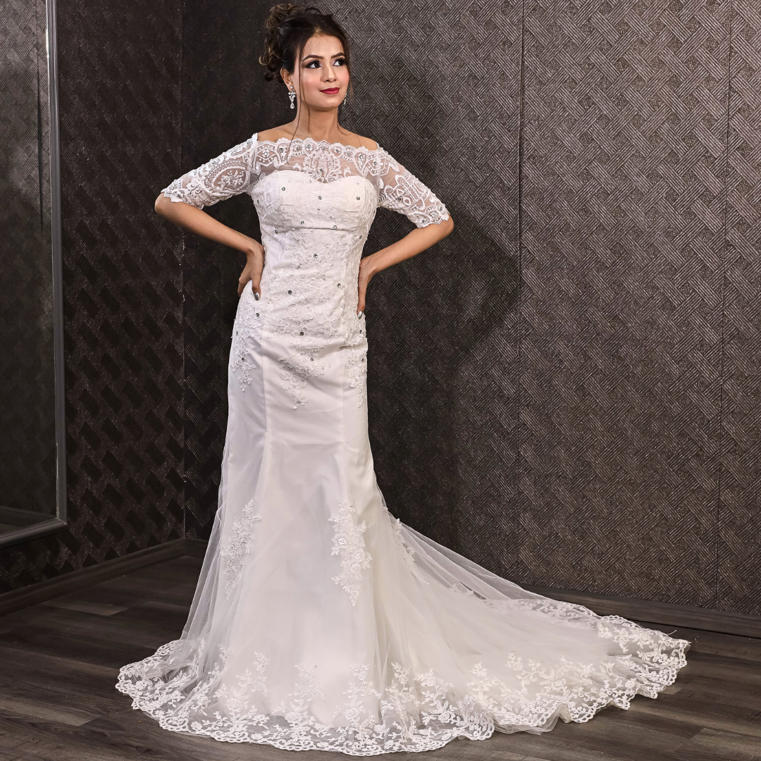 Elegant fitted bridal gown with intricate lace details and a flowing lace-edged train