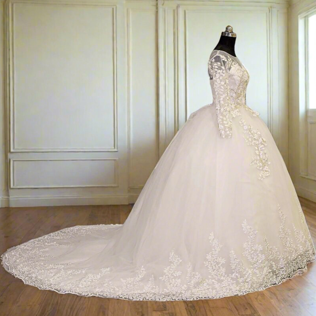 Elegant Christian bridal ball gown with long lace sleeves, floral embroidery, and flowing cathedral train
