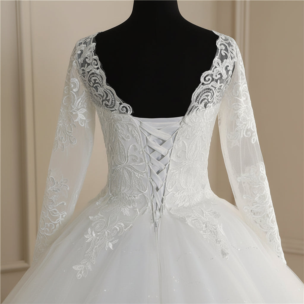 Elegant long-sleeve Christian wedding gown with embroidered lace bodice and full tulle skirt