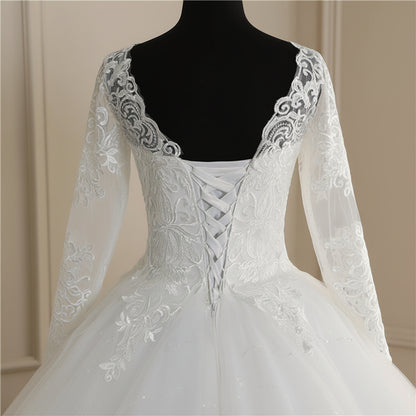Elegant long-sleeve Christian wedding gown with embroidered lace bodice and full tulle skirt