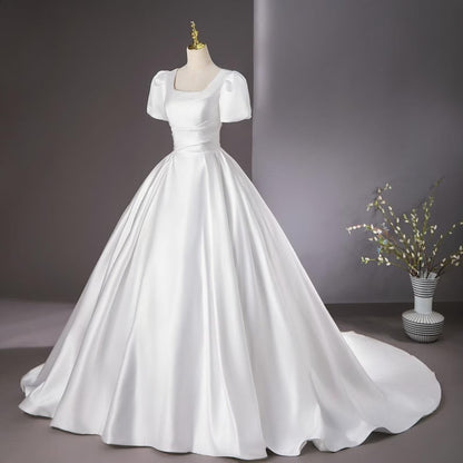 Full-length view of White Bridal Gown Satin with Train with train spread on floor — GownLink GLHMST8