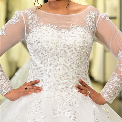 Floral lace Christian bridal gown with sheer long sleeves and graceful ball gown silhouette
