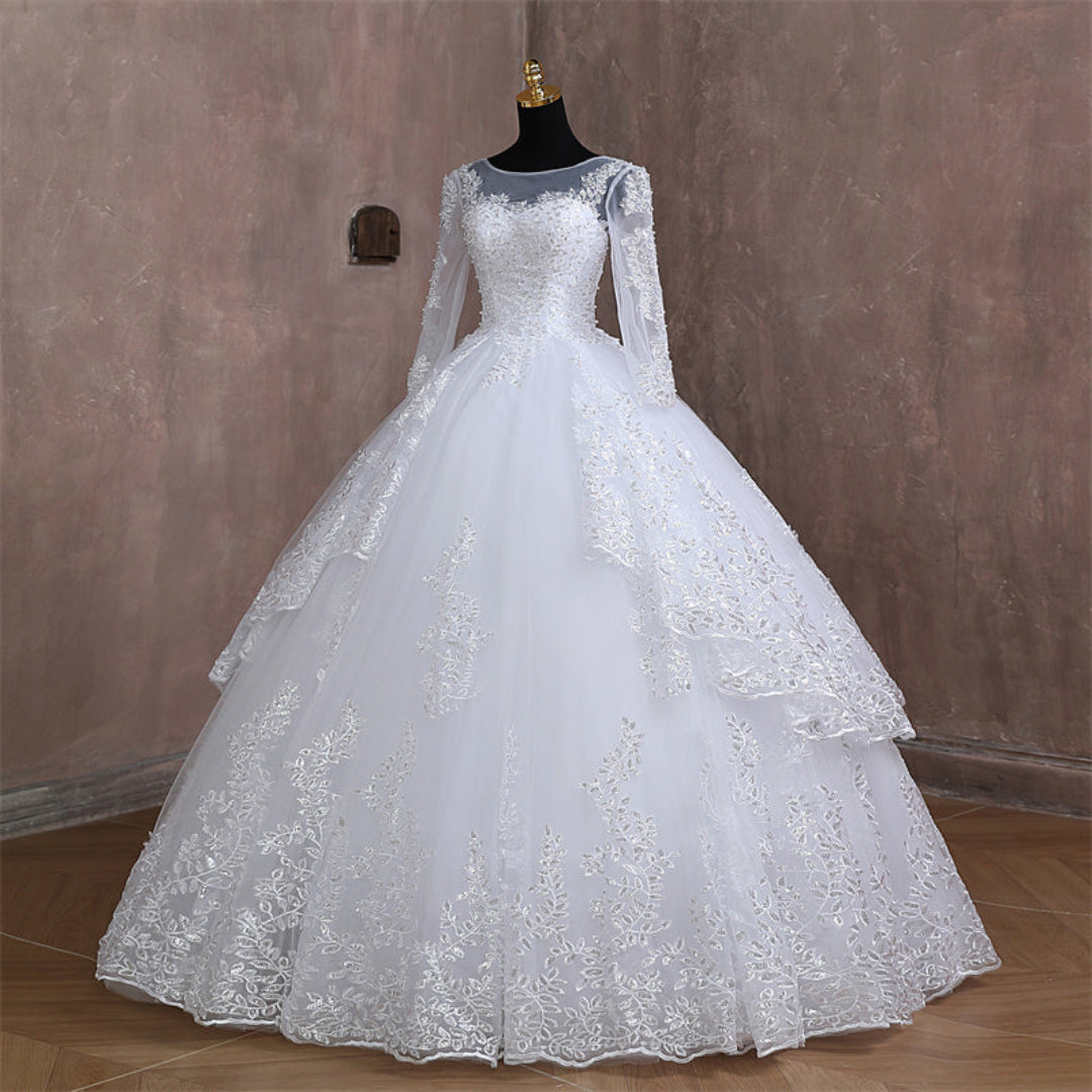 Christian bridal gown with lace appliqués, layered tulle skirt, and elegant bridal finish
