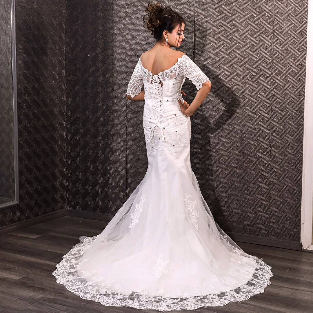 White lace mermaid bridal dress featuring floral embroidery and a graceful train