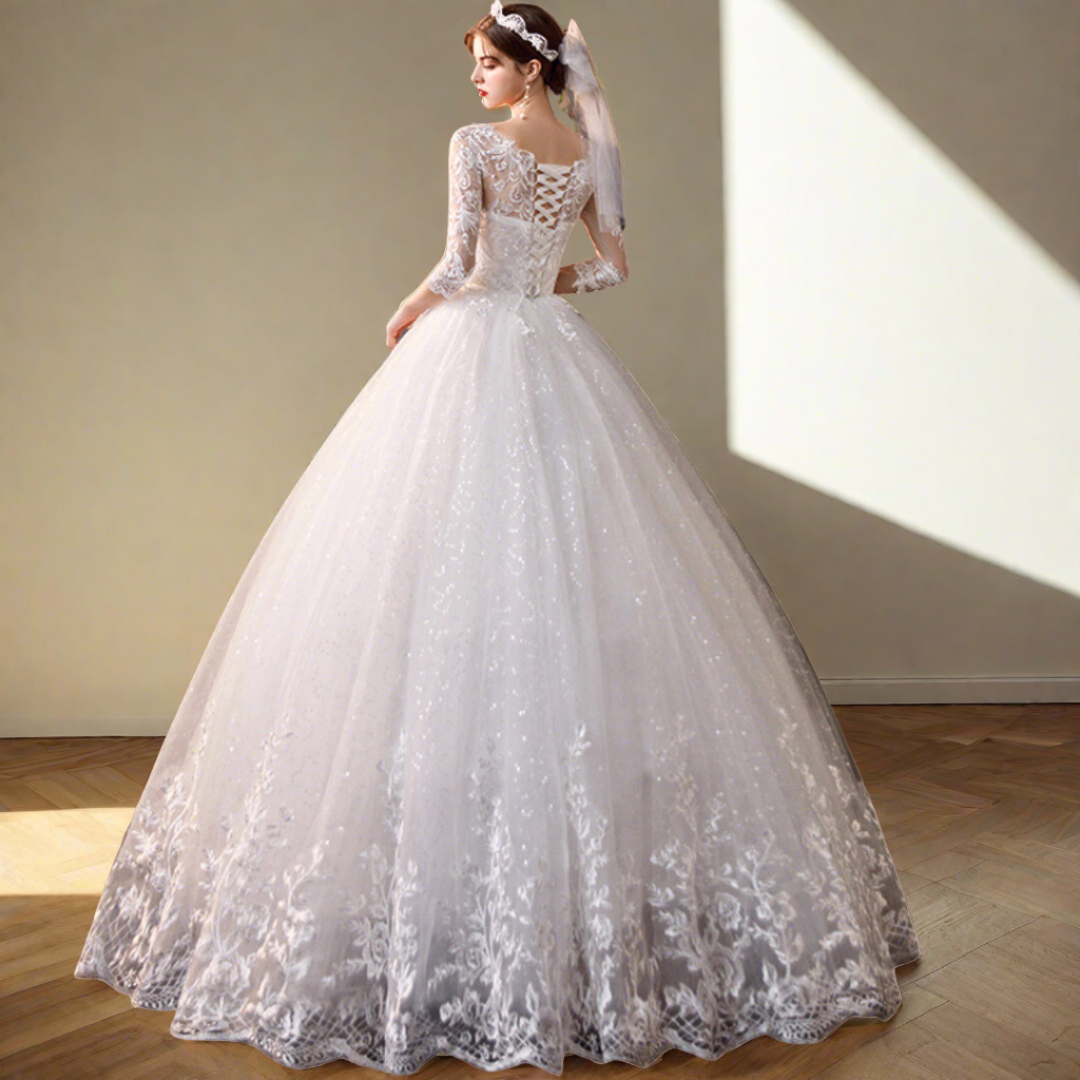 Premium white bridal ball gown featuring floral lace appliqué and elegant craftsmanship