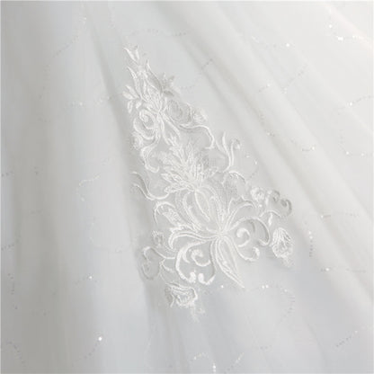 Princess-style Christian bridal gown in white with lace appliqués, fitted bodice, and sweeping train