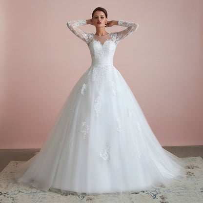 Princess-style Christian wedding gown with lace bodice, sheer sleeves, and voluminous skirt